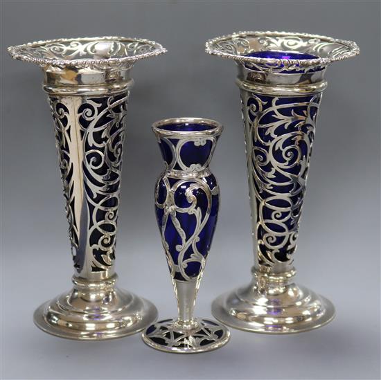 A pair of Edwardian silver vases, William Gibson, London, 1902, 7in. and a small overlaid vase, 5in.